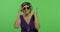 Elderly woman listens to music in headphones and dances. Grandmother. Chroma key