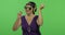 Elderly woman listens to music in headphones and dances. Grandmother. Chroma key