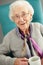 Elderly woman looking comfortable drinking tea