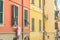 Elderly woman looking out of her window, taken in Riomaggiore, Italy