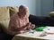 Elderly woman making necklaces