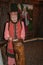 An elderly woman in national costume conducts a tour of the museum.