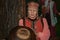 An elderly woman in national costume conducts a tour of the museum.