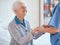 Elderly woman, nurse holding hands and nursing home support with medical professional exam, retirement healthcare and