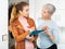 Elderly woman participating in survey at home by female social worker