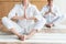 elderly woman performing namaste gesture while practicing yoga