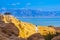 Elderly woman practices yoga near the Dead Sea