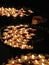 Elderly woman in prayer and lit a candle in the Church