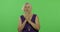 An elderly woman prays with hands clasped together. Old grandmother. Chroma key