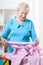 Elderly woman preparing shirt to ironing