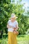 Elderly woman putting apples into the basket