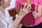 Elderly woman receiving a gift from daughter