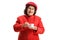 Elderly woman in a red coat standing and drinking an espresso coffee