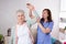 An elderly woman and a rehabilitation doctor - rehabilitation and health concept of older people