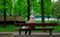An Elderly Woman Resting on a bench in the park.