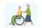 An elderly woman rolls her disabled husband in a wheelchair.