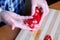 An elderly woman\'s hands chop red bell peppers