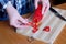 An elderly woman\'s hands chop red bell peppers