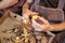 Elderly woman\'s hands doing domestic work of peeling potatoes.