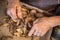 Elderly woman\'s hands doing domestic work of peeling potatoes.