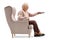Elderly woman seated in an armchair changing channels on TV