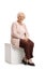 Elderly woman seated on a cube