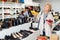 Elderly woman selecting footwear in shoeshop