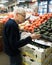 A Elderly Woman Shopping for Avocados