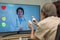Elderly woman sit at home having online consultation with doctor