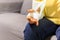 Elderly woman sitting on sofa with hand injured on a plaster cast.