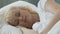 Elderly woman sleeping with head resting on pillow, health improvement resort