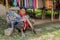 Elderly woman smokes with bamboo cane