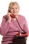 The elderly woman speaks on the phone