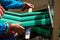 An elderly woman spins on a handicraft loom. Outdoor