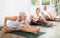 Elderly woman stretches and prepares to perform Jana Shirshasana