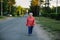 An elderly woman strolls through the village. Nature.