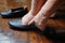 Elderly woman swollen feet putting on shoes