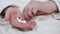 Elderly woman taking medicines, picking pills from hand, closeup view.