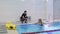 Elderly woman trains in swimming pool with coach