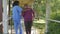 Elderly woman with walking handicap helped by nurse at hospital - Active seniors outdoor