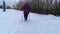 An elderly woman walks with sticks for Nordic walking