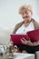 Elderly woman watching pictures