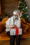 Elderly woman wearing face mask sad and alone at Christmas
