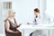 elderly woman wearing a medical mask on examination by a nurse stethoscope