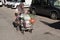 Elderly woman in a wheelchair is leaving the market with food