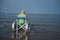 Elderly woman in a wheelchair in the sea