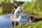 Elderly woman on a white horse enjoying a beautiful day