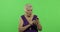 An elderly woman works on a smartphone. Old grandmother smiles. Chroma key