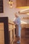 Elderly woman writing while standing behind bar counter