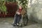 Elderly Woman Writing in Wheelchair - Horizontal